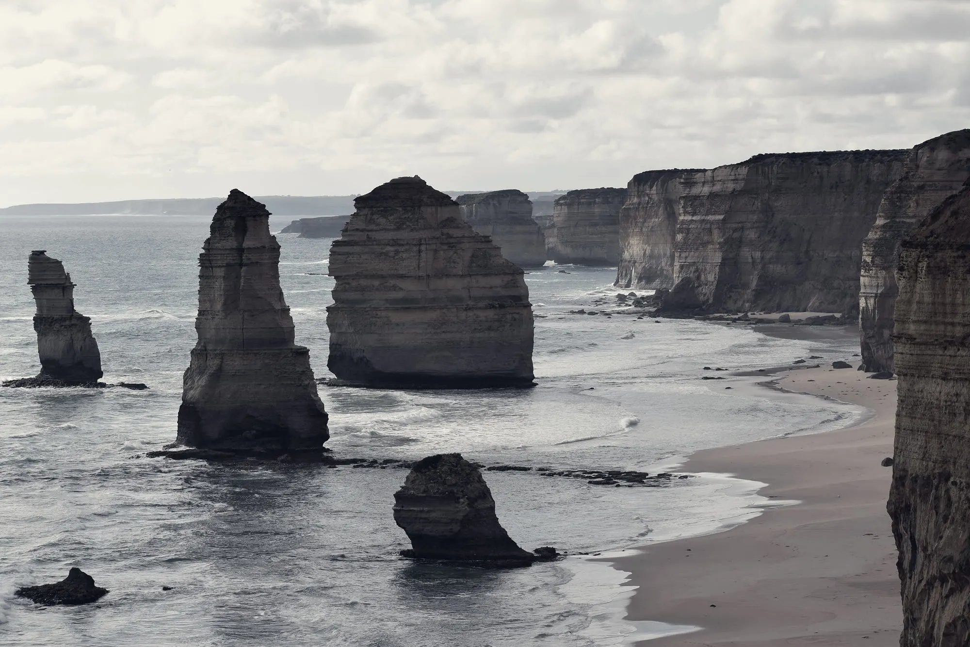 The same coast under flat grey overcast