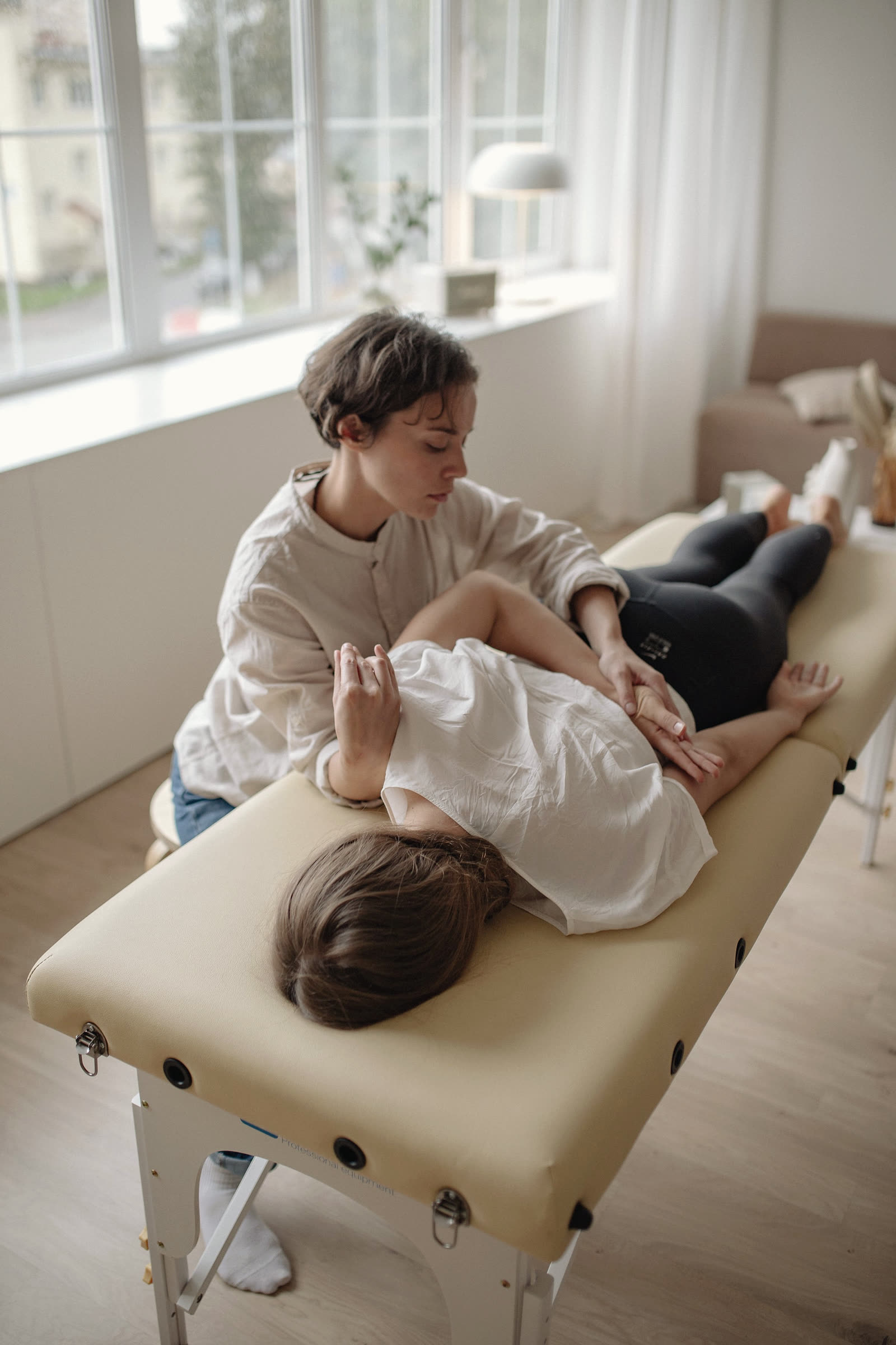 A physiotherapist working on a patient's shoulder